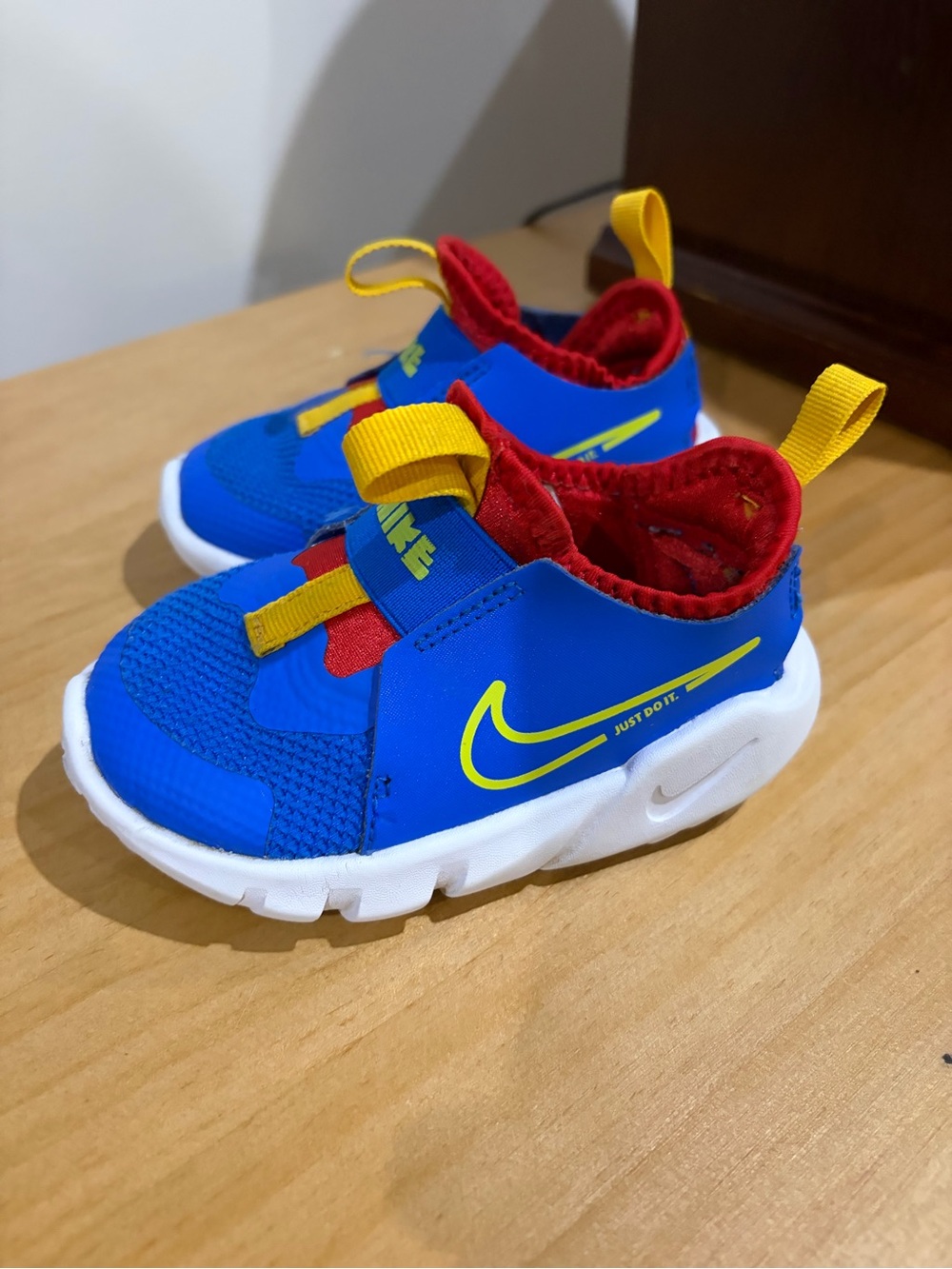 Nike Kids Bright Blue Slip-On Sneakers with Red & Yellow Accents